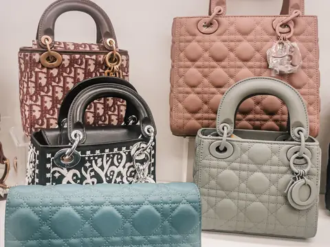 A group of Lady Dior bags in pink, grey, black Oblique canvas and blue cannage leather